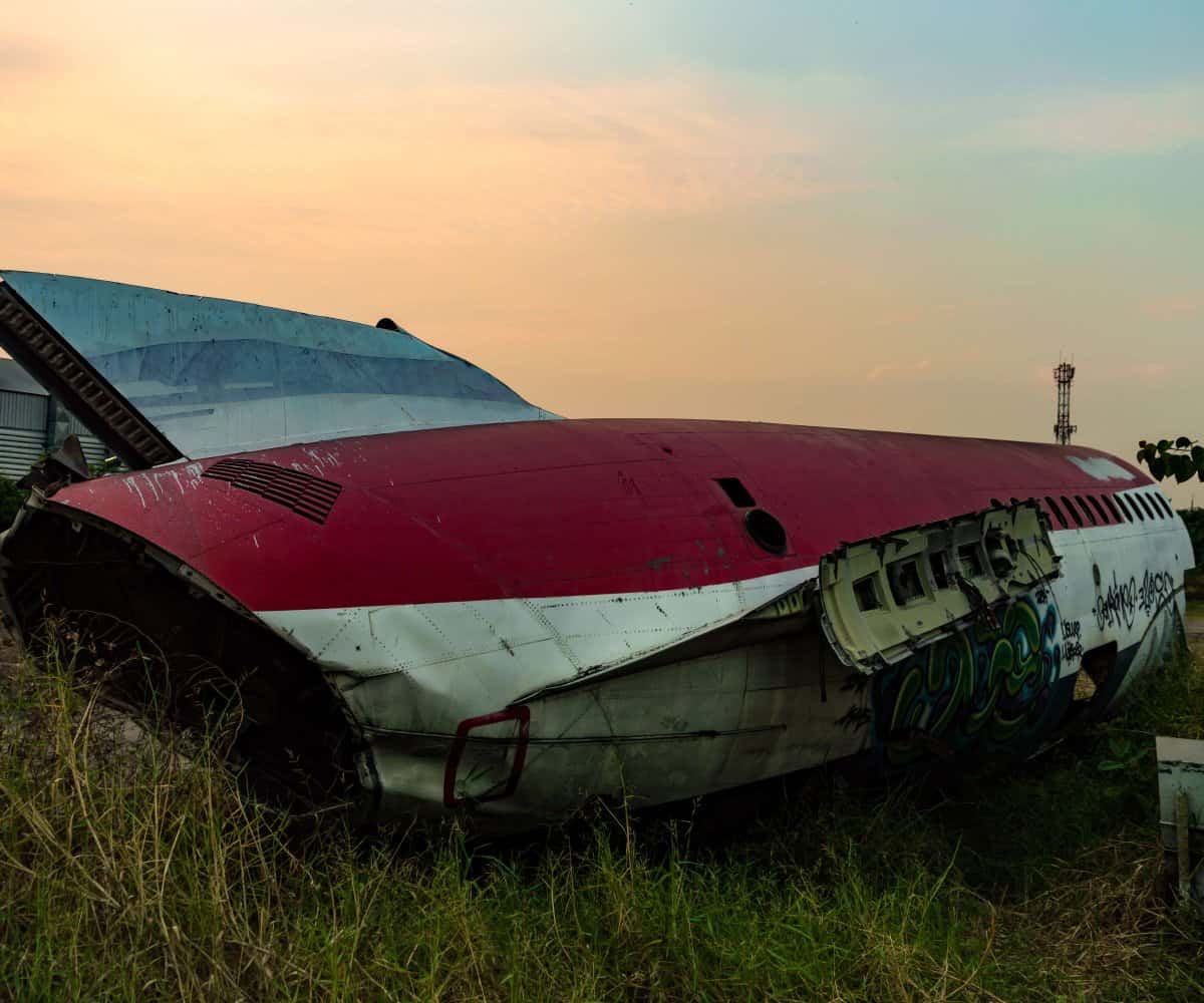 Beautiful sunset in the background as a dismantled plane lies motionless. Bangkok, Thailand.