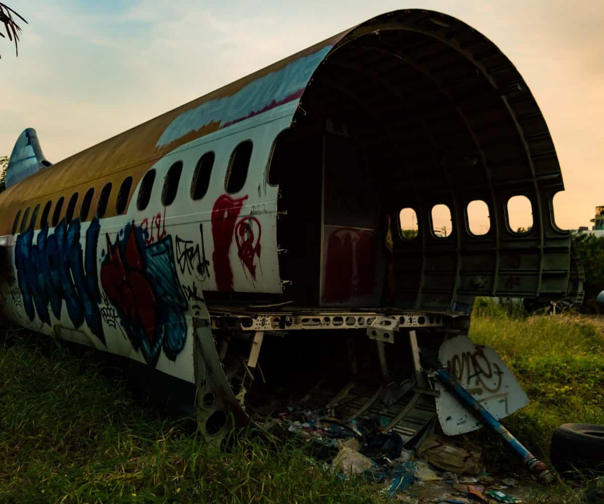 The decaying shell of a abandoned commercial plane, Bangkok's Plane Graveyard, Thailand.