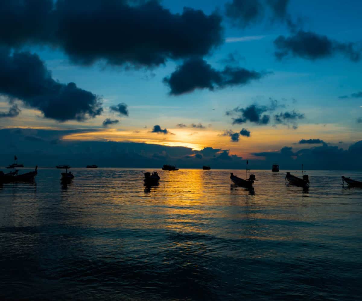 A beautiful Koh Tao sunset, silhouetted long tail boats on calm waters