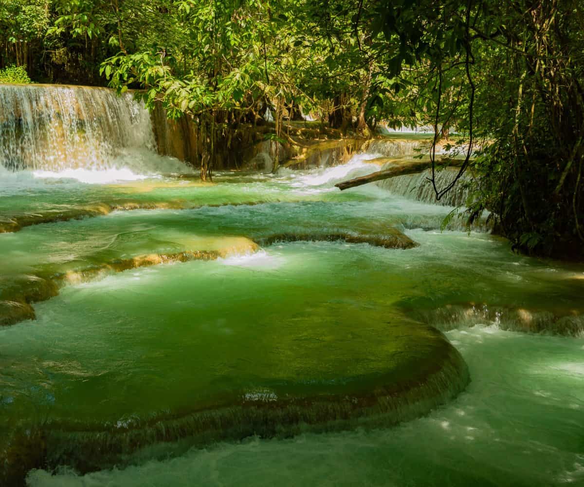 Smaller swimming holes are dotted around Kuang Si falls, Laos