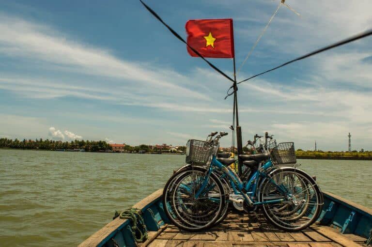 Crossing a river during a Hoi An free bike tour