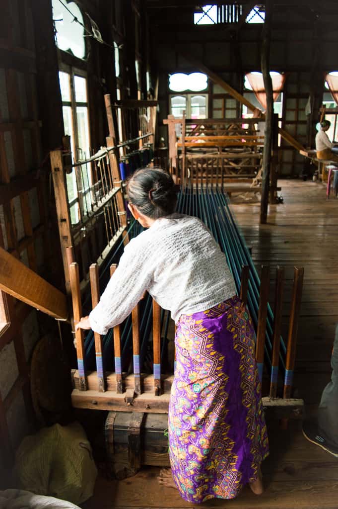 Lady weaving fabric at local inle Lake handicraft store