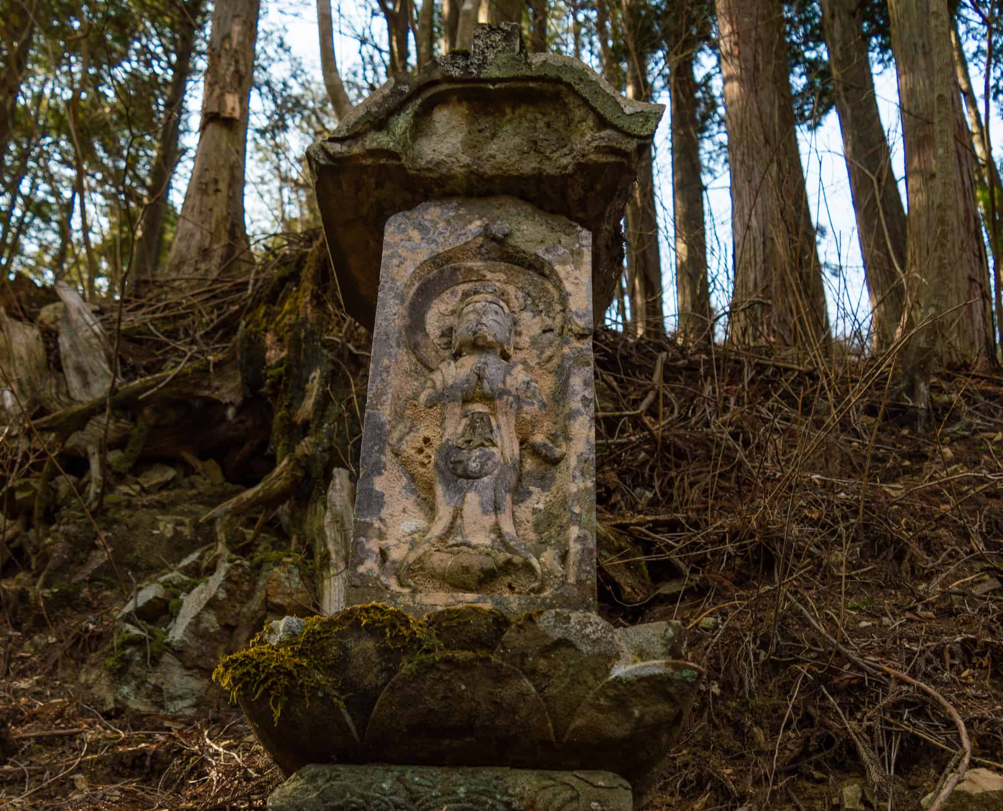 Notice 13 little stone statues along the temple's Pilgrimage Path
