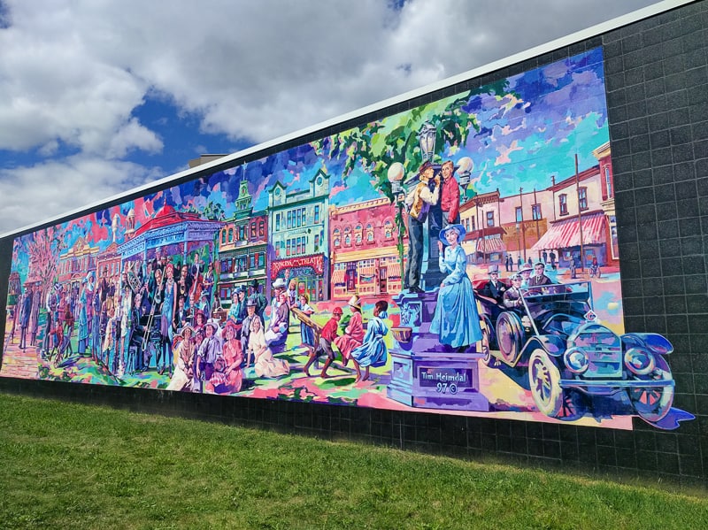 This colourful mural is painted on the wall right next to Edmonton's street car Strathcona Station