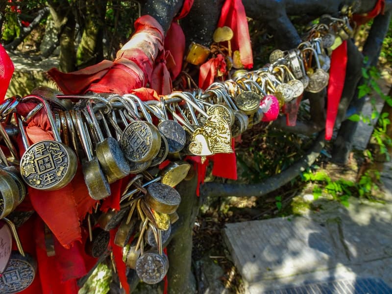 Red ribbons and padlocks line the trail around Tianmen Mountain in China