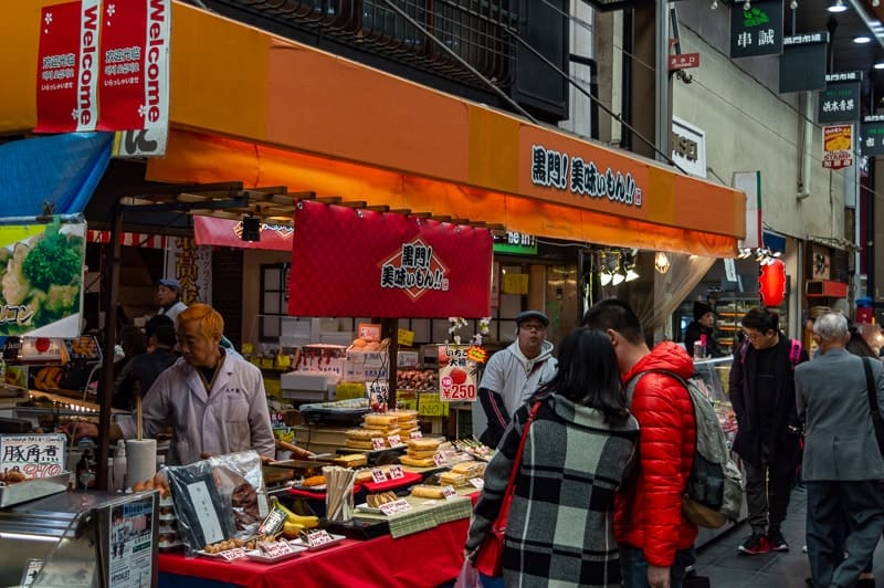 Visit Kuromon Ichiba Market for fresh seafood and the cheapest street food in Osaka