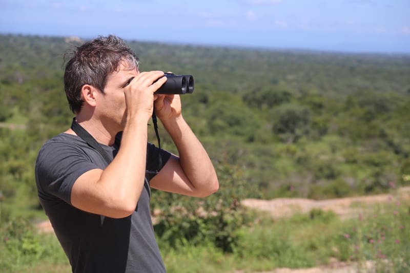 Looking through binoculars on a road trip